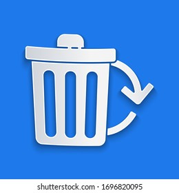 Paper cut Recycle bin with recycle symbol icon isolated on blue background. Trash can icon. Garbage bin sign. Recycle basket sign. Paper art style. Vector Illustration