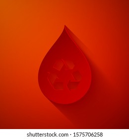 Paper cut Recycle clean aqua icon isolated on red background. Drop of water with sign recycling. Paper art style. Vector Illustration