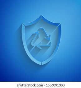Paper cut Recycle symbol inside shield icon isolated on blue background. Eco protection sign. Paper art style. Vector Illustration