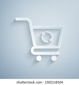 Paper cut Refresh shopping cart icon isolated on grey background. Online buying concept. Delivery service sign. Update supermarket basket symbol. Paper art style. Vector Illustration