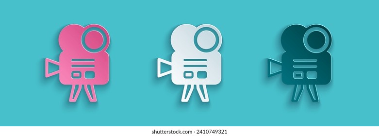 Paper cut Retro cinema camera icon isolated on blue background. Video camera. Movie sign. Film projector. Paper art style. Vector