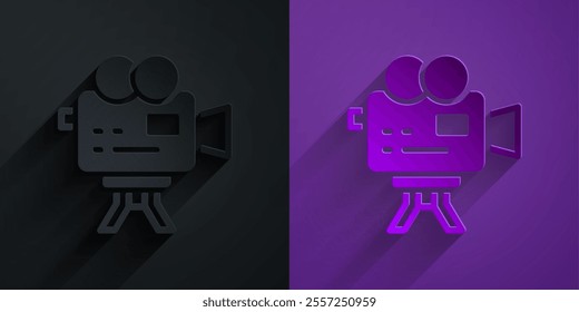 Paper cut Retro cinema camera icon isolated on black on purple background. Video camera. Movie sign. Film projector. Paper art style. Vector