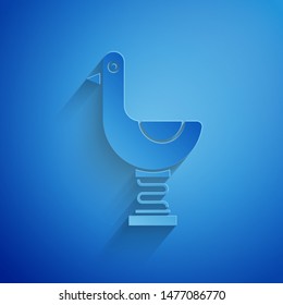 Paper cut Riding kid duck icon isolated on blue background. Paper art style. Vector Illustration