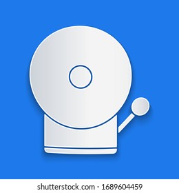 Paper cut Ringing alarm bell icon isolated on blue background. Fire alarm system. Service bell, handbell sign, notification symbol. Paper art style. Vector Illustration
