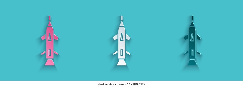 Paper cut Rocket icon isolated on blue background. Paper art style. Vector Illustration