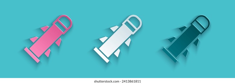 Paper cut Rocket icon isolated on blue background. Paper art style. Vector
