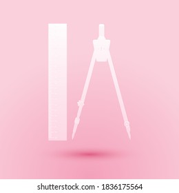 Paper cut Ruler and drawing compass icon isolated on pink background. Drawing professional instrument. Geometric equipment. Education sign. Paper art style. Vector.