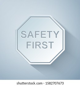 Paper cut Safety First octagonal shape icon isolated on grey background. Paper art style. Vector Illustration