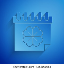 Paper cut Saint Patricks day with calendar icon isolated on blue background. Four leaf clover symbol. Date 17 March. Paper art style. Vector Illustration
