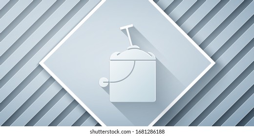 Paper cut Sand in bucket with shovel icon isolated on grey background. Plastic kid toy. Summer icon. Paper art style. Vector Illustration