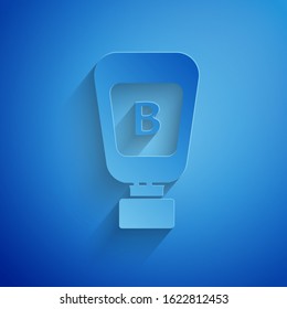 Paper cut Sauce bottle icon isolated on blue background. Ketchup, mustard and mayonnaise bottles with sauce for fast food. Paper art style. Vector Illustration