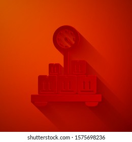 Paper cut Scale with cardboard box icon isolated on red background. Logistic and delivery. Weight of delivery package on a scale. Paper art style. Vector Illustration