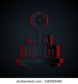 Paper cut Scale with cardboard box icon isolated on black background. Logistic and delivery. Weight of delivery package on a scale. Paper art style. Vector Illustration