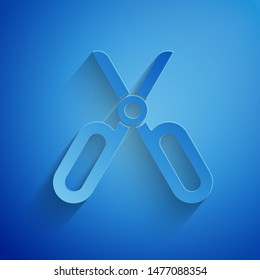 Paper cut Scissors icon isolated on blue background. Tailor symbol. Cutting tool sign. Paper art style. Vector Illustration