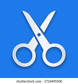 Paper cut Scissors icon isolated on blue background. Cutting tool sign. Paper art style. Vector Illustration