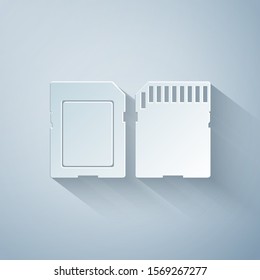 Paper cut SD card icon isolated on grey background. Memory card. Adapter icon. Paper art style. Vector Illustration