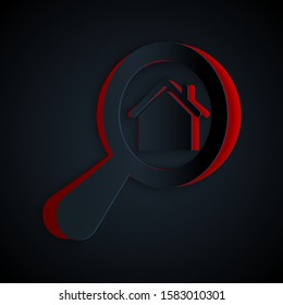 Paper cut Search house icon isolated on black background. Real estate symbol of a house under magnifying glass. Paper art style. Vector Illustration