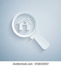 Paper cut Search house icon isolated on grey background. Real estate symbol of a house under magnifying glass. Paper art style. Vector.