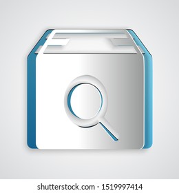 Paper cut Search package icon isolated on grey background. Parcel tracking symbol. Magnifying glass and cardboard box. Logistic and delivery. Paper art style. Vector Illustration