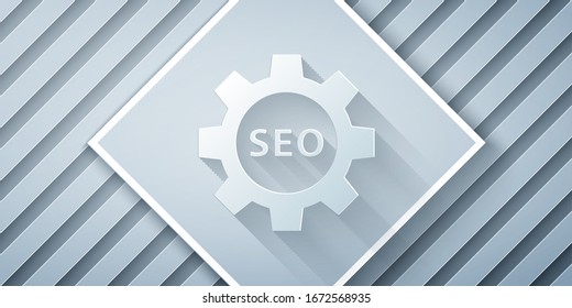 Paper cut Seo tag with gear wheel icon isolated on grey background. Paper art style. Vector Illustration