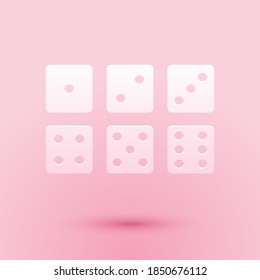 Paper cut Set of six dices icon isolated on pink background. Paper art style. Vector.