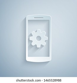 Paper cut Setting on smartphone icon isolated on grey background. Mobile phone and gear. Adjusting, service, setting, maintenance, repair, fixing. Paper art style. Vector Illustration
