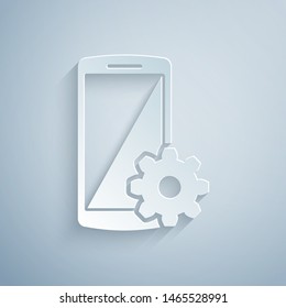 Paper cut Setting on smartphone icon isolated on grey background. Mobile phone and gear. Adjusting, service, setting, maintenance, repair, fixing. Paper art style. Vector Illustration