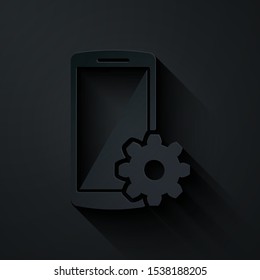 Paper cut Setting on smartphone icon isolated on black background. Mobile phone and gear. Adjusting, service, setting, maintenance, repair, fixing. Paper art style. Vector Illustration