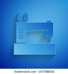 Paper cut Sewing machine icon isolated on blue background. Paper art style. Vector Illustration