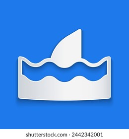 Paper cut Shark fin in ocean wave icon isolated on blue background. Paper art style. Vector