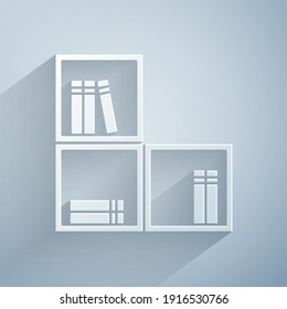 Paper cut Shelf with books icon isolated on grey background. Shelves sign. Paper art style. Vector
