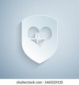 Paper cut Shield and heart rate icon isolated on grey background. Health protection concept. Health care. Paper art style. Vector Illustration