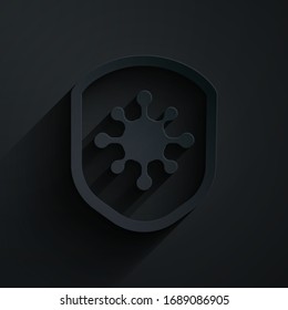 Paper cut Shield protecting from virus, germs and bacteria icon isolated on black background. Immune system concept. Corona virus 2019-nCoV. Paper art style. Vector Illustration