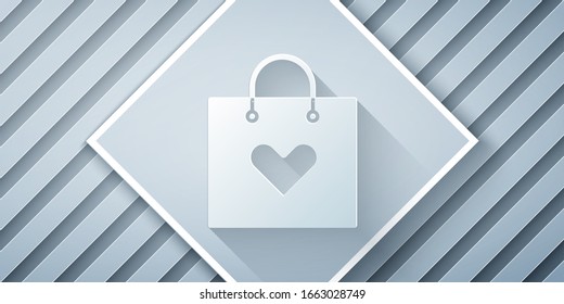 Paper cut Shopping bag with heart icon isolated on grey background. Shopping bag shop love like heart icon. Valentines day symbol. Paper art style. Vector Illustration