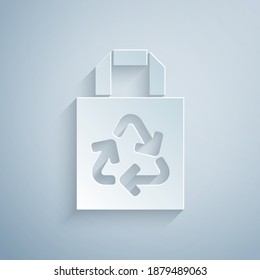Paper cut Paper shopping bag with recycle icon isolated on grey background. Bag with recycling symbol. Paper art style. Vector.