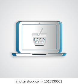 Paper cut Shopping basket on screen laptop icon isolated on grey background. Concept e-commerce, e-business, online business marketing. Paper art style. Vector Illustration