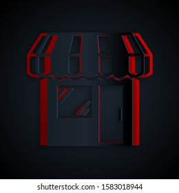 Paper cut Shopping building or market store icon isolated on black background. Shop construction. Paper art style. Vector Illustration