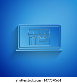Paper cut Shopping building on screen laptop icon isolated on blue background. Concept e-commerce, e-business, online business marketing. Paper art style. Vector Illustration
