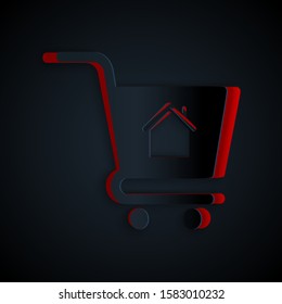 Paper cut Shopping cart with house icon isolated on black background. Buy house concept. Home loan concept, rent, buying a property. Paper art style. Vector Illustration