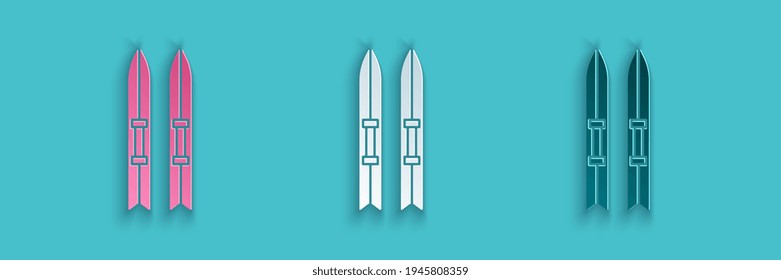 Paper cut Ski and sticks icon isolated on blue background. Extreme sport. Skiing equipment. Winter sports icon. Paper art style. Vector