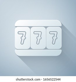 Paper cut Slot machine with lucky sevens jackpot icon isolated on grey background. Paper art style. Vector Illustration