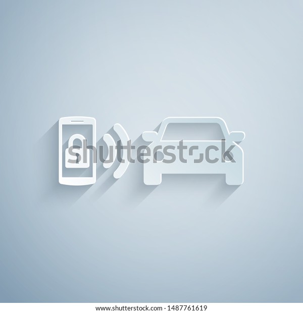 Paper cut Smart car alarm\
system icon isolated on grey background. The smartphone controls\
the car security on the wireless. Paper art style. Vector\
Illustration
