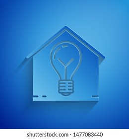 Paper cut Smart house and light bulb icon isolated on blue background. Paper art style. Vector Illustration