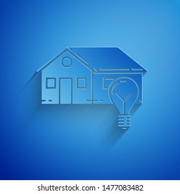 Paper cut Smart house and light bulb icon isolated on blue background. Paper art style. Vector Illustration