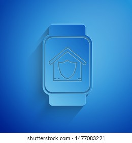 Paper cut Smart watch with house under protection icon isolated on blue background. Protection, safety, security, protect, defense concept. Paper art style. Vector Illustration