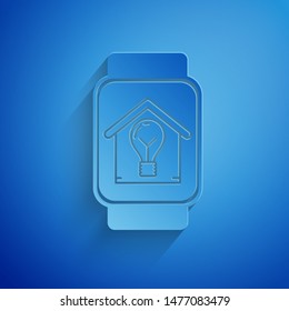 Paper cut Smart watch with smart house and light bulb icon isolated on blue background. Paper art style. Vector Illustration