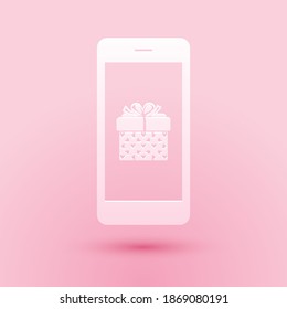 Paper cut Smartphone with gift box and heart symbol on the screen icon isolated on pink background. Valentine's day symbol. The online store, e-shopping. Paper art style. Vector.
