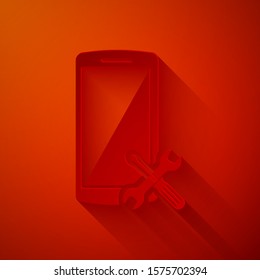 Paper cut Smartphone with screwdriver and wrench icon isolated on red background. Adjusting, service, setting, maintenance, repair, fixing. Paper art style. Vector Illustration