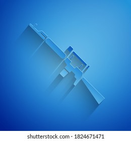 Paper cut Sniper rifle with scope icon isolated on blue background. Paper art style. Vector Illustration