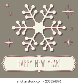 Paper cut snowflake and a frame with New Year greetings over vintage brown backgrounds.